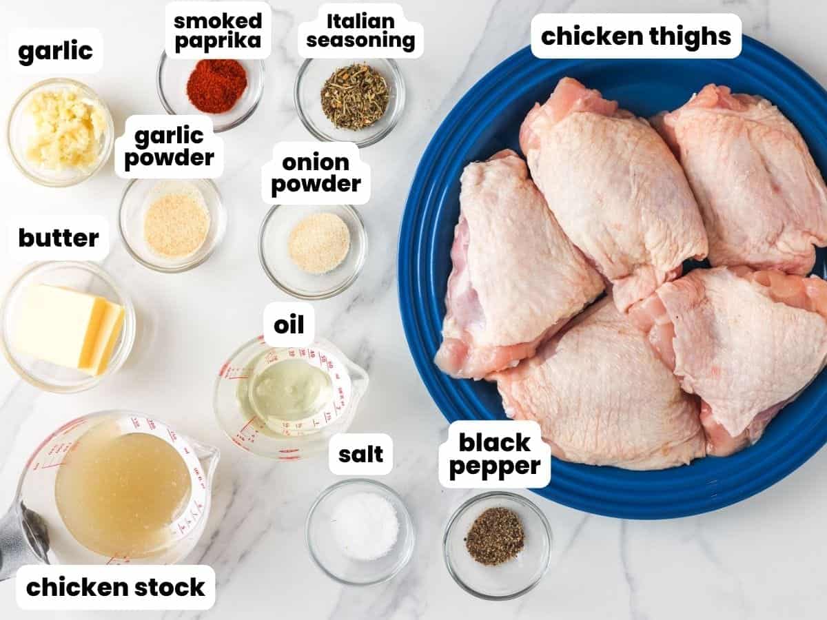 a plate of raw chicken thighs next to several small bowls of ingredients that will be used to cook the chicken thighs in a crockpot. 