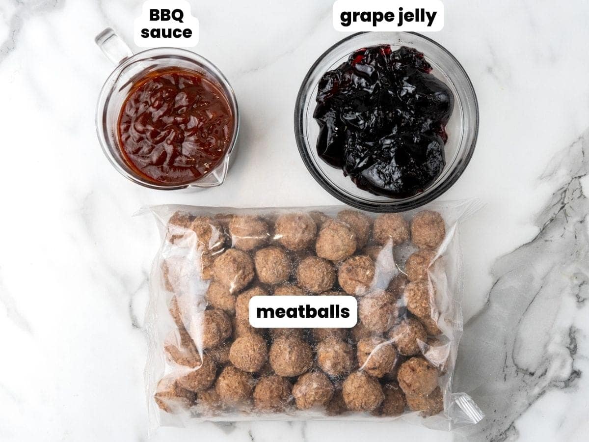 Ingredients needed to make crockpot grape jelly meatballs including a bag of fully cooked meatballs, bbq sauce, and grape jelly.