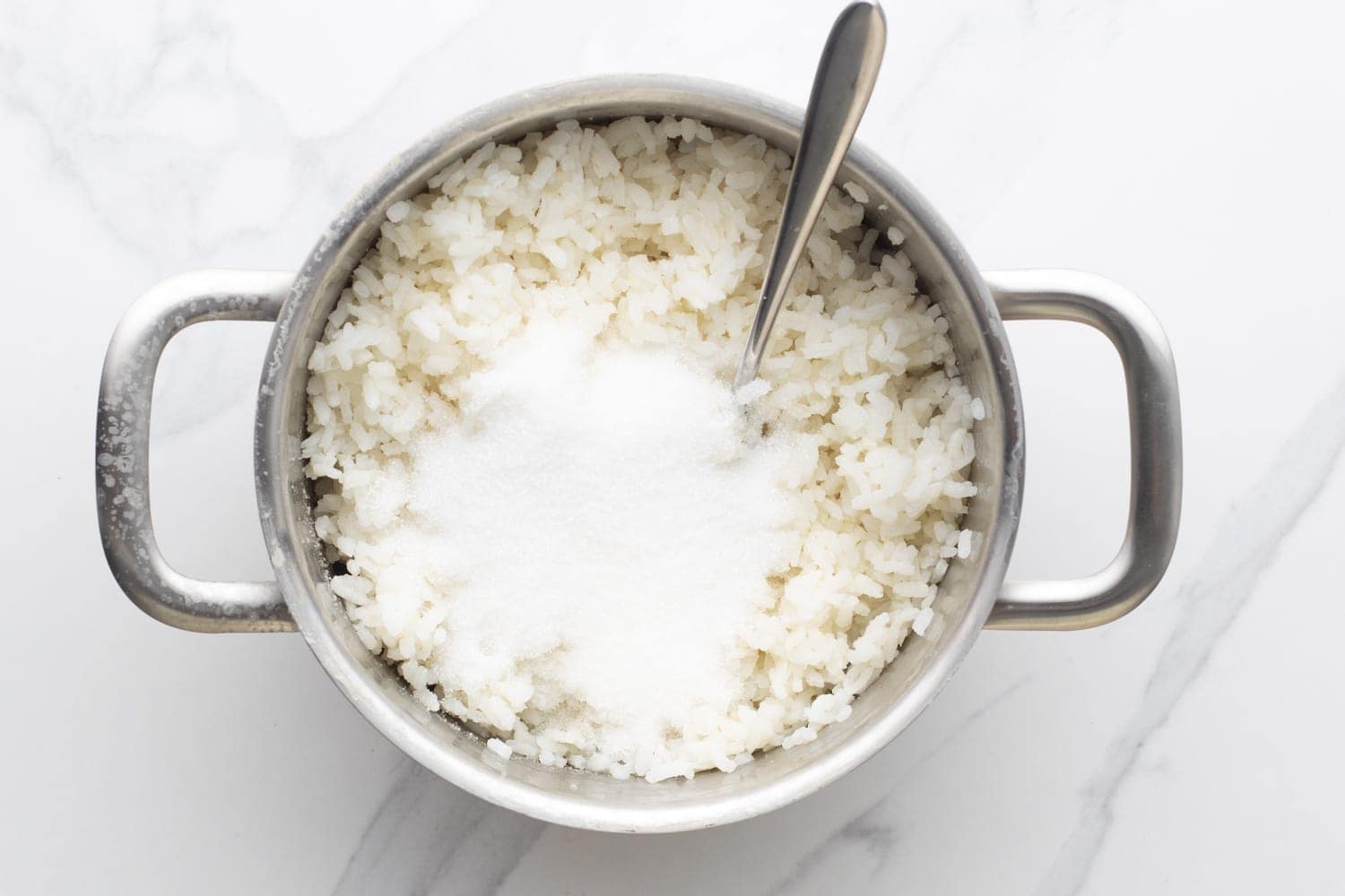 a pot of cooked arborio rice with sugar added.