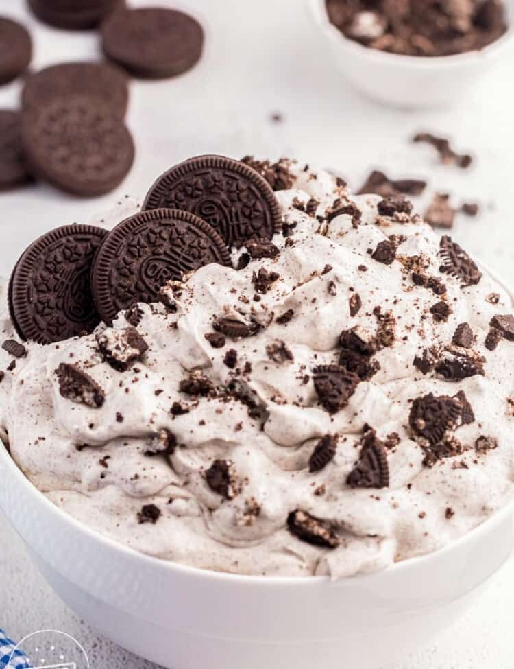 Oreo fluff dessert in a large white bowl, topped with oreo cookies