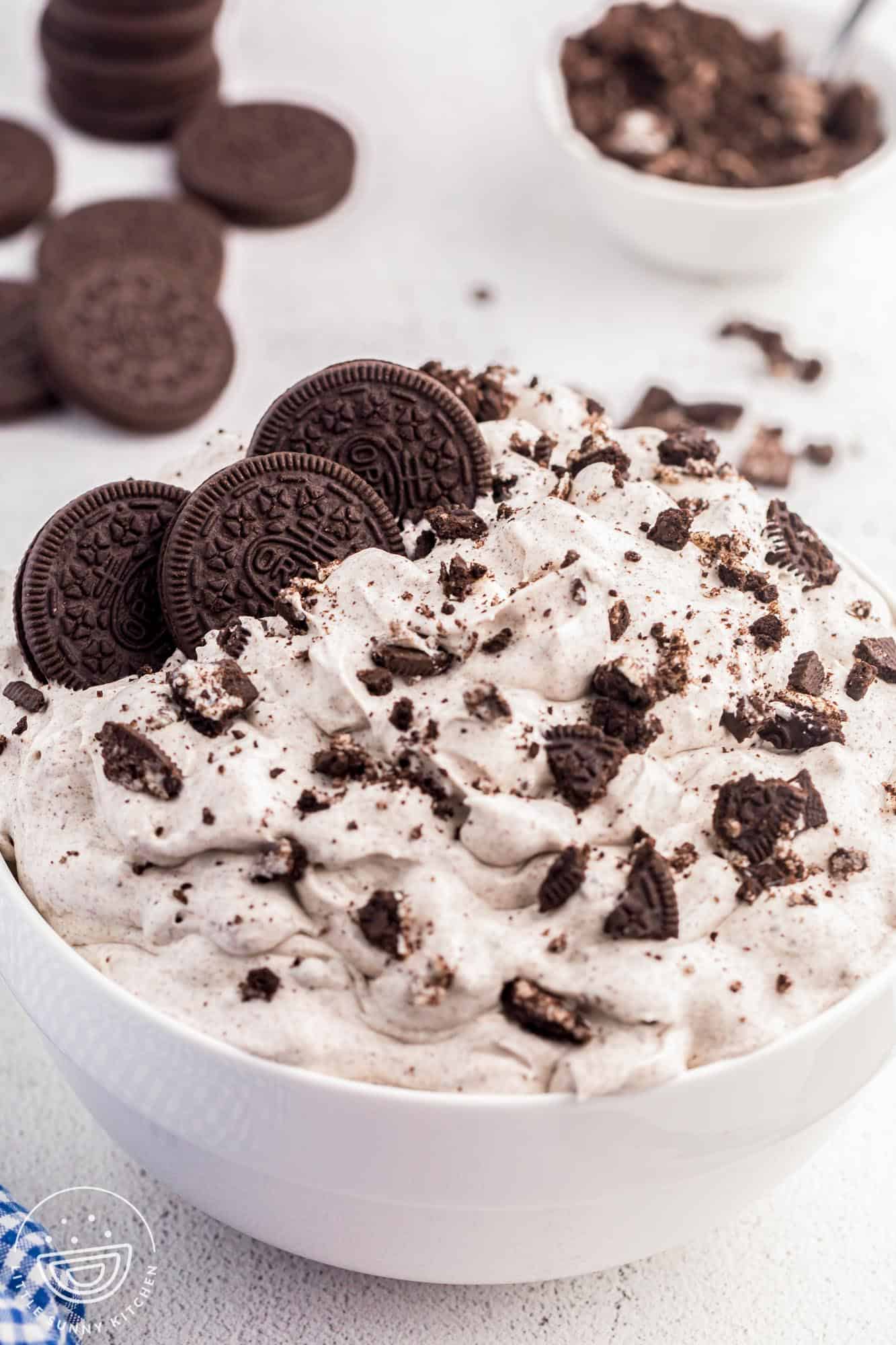 Oreo fluff dessert in a large white bowl, topped with oreo cookies