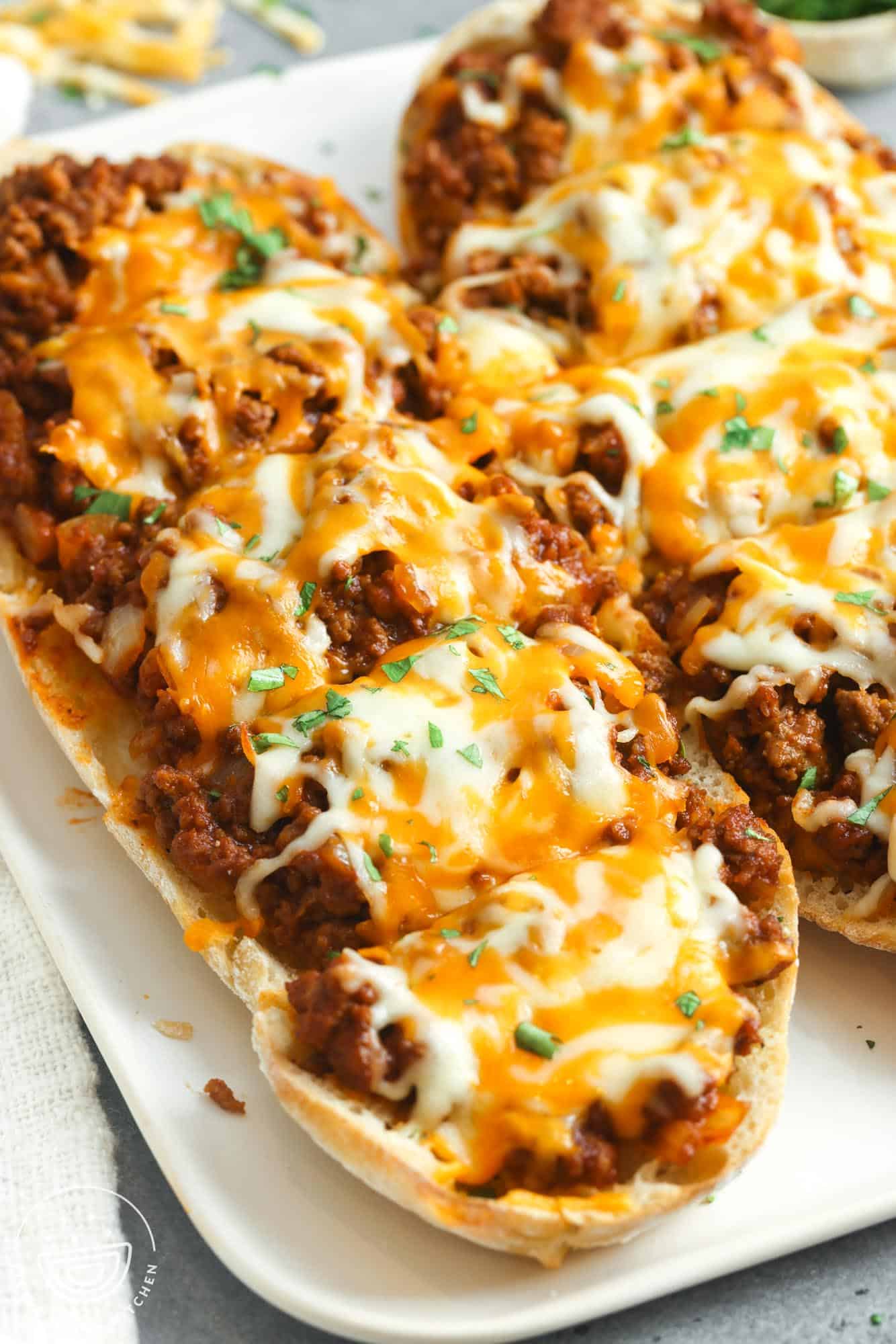 two large pieces of ciabatta topped with sloppy joe meat and melted cheese