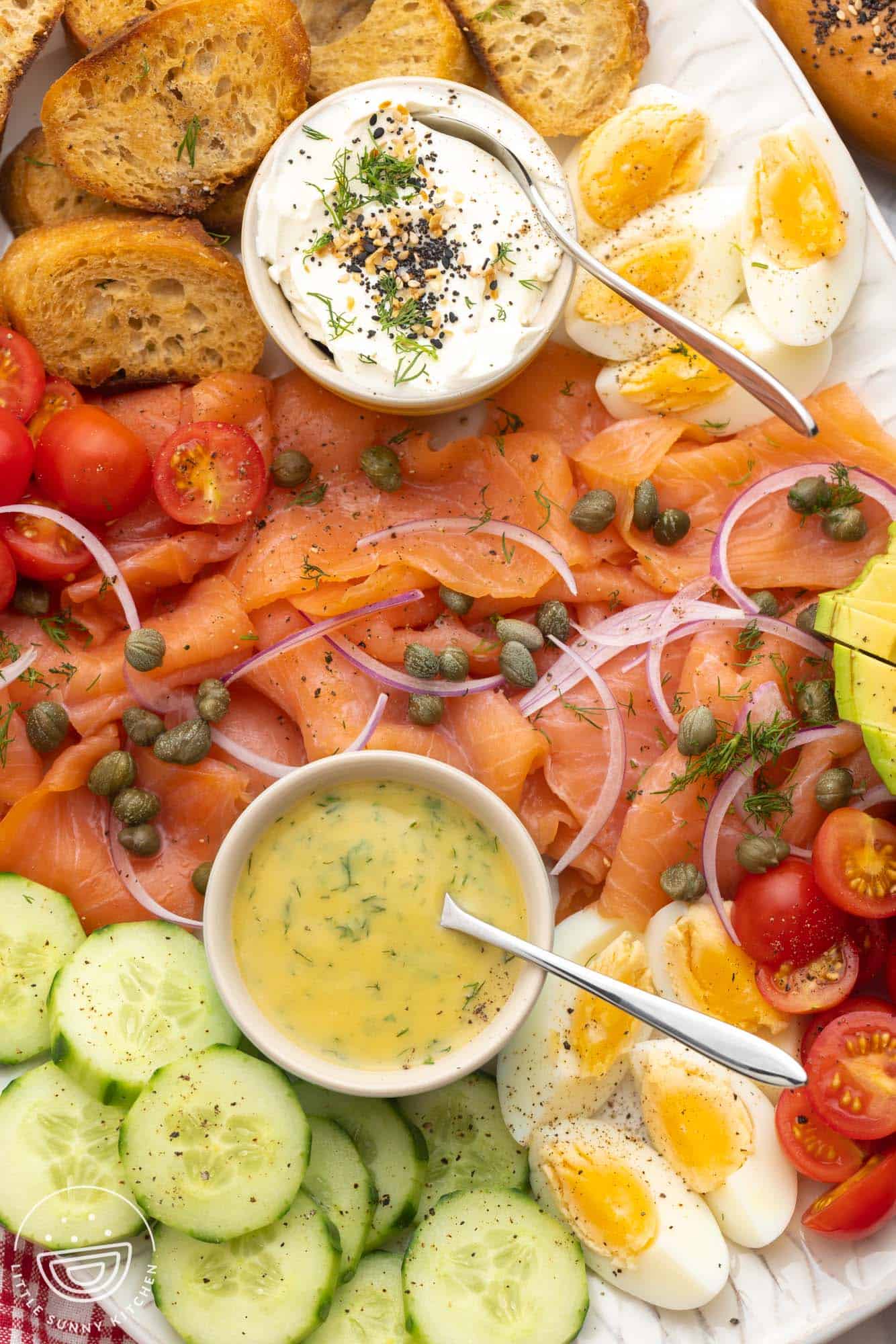 closeup of a smoked salmon platter with homemade sauces.