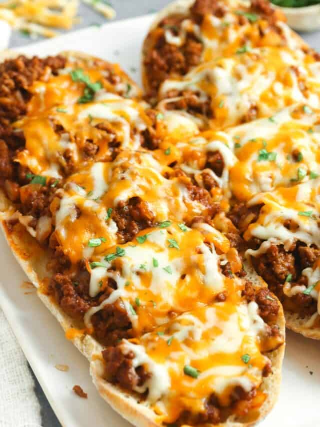 two large pieces of ciabatta topped with sloppy joe meat and melted cheese