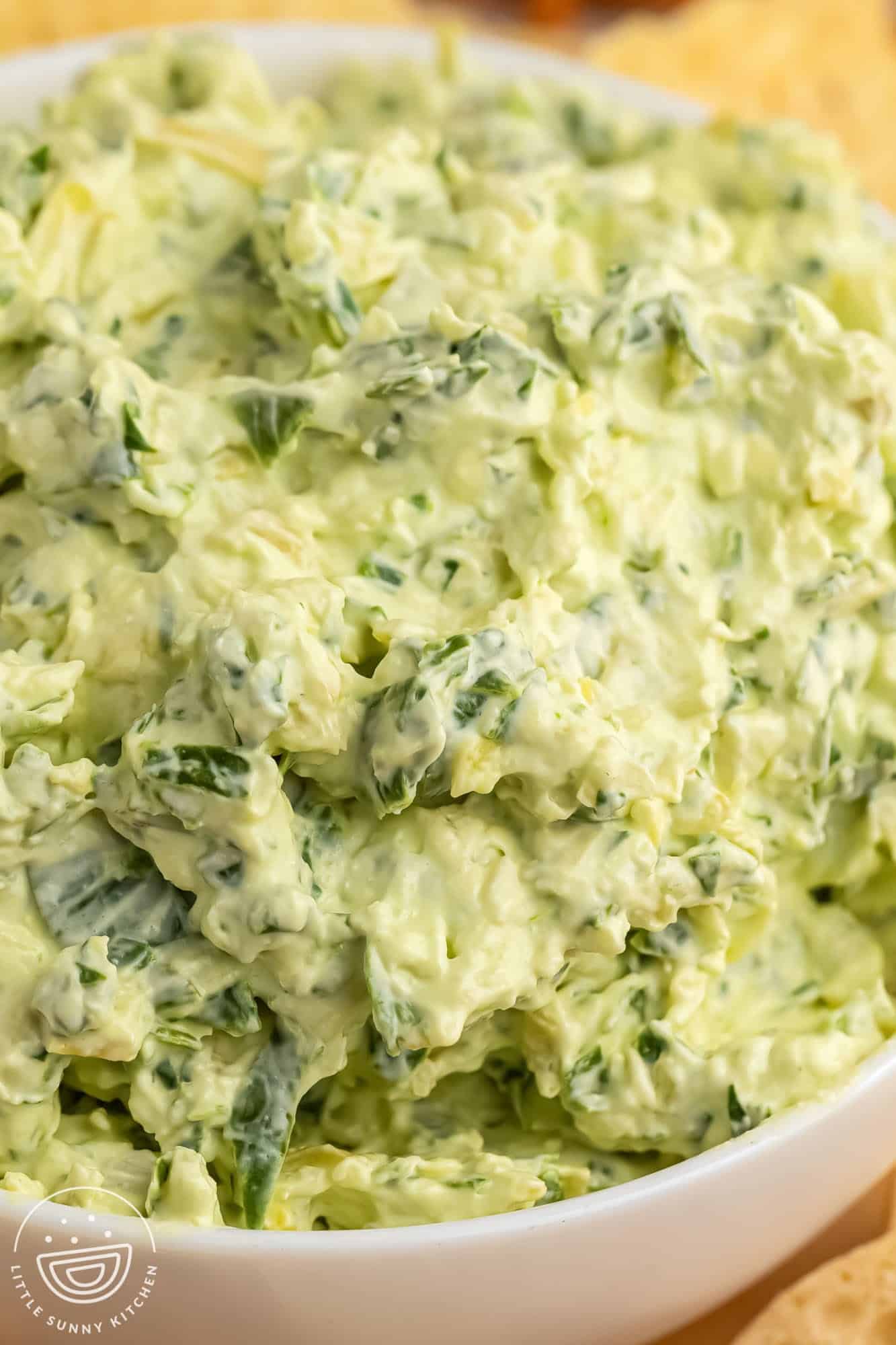 closeup of creamy spinach artichoke dip with water chestnuts.