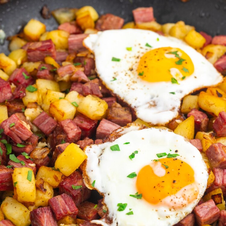 a skillet of homemade corned beef hash topped with two fried eggs.
