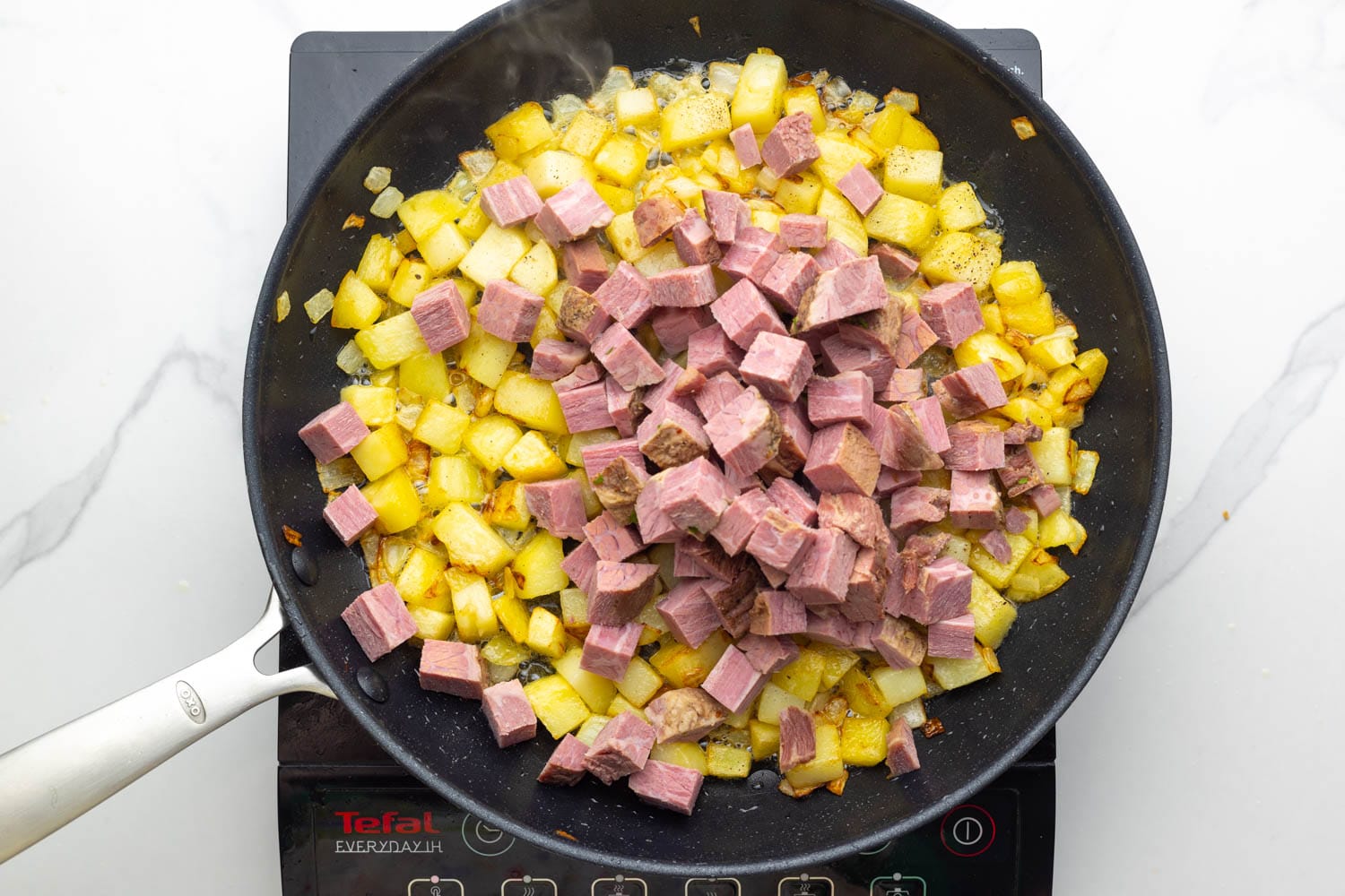 cooked, cubed corned beef added to cooked diced potatoes to make corned beef hash.