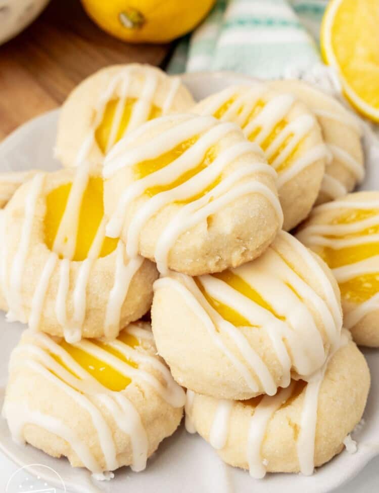 a plate holding a stack of lemon curd cookies with drizzled icing.