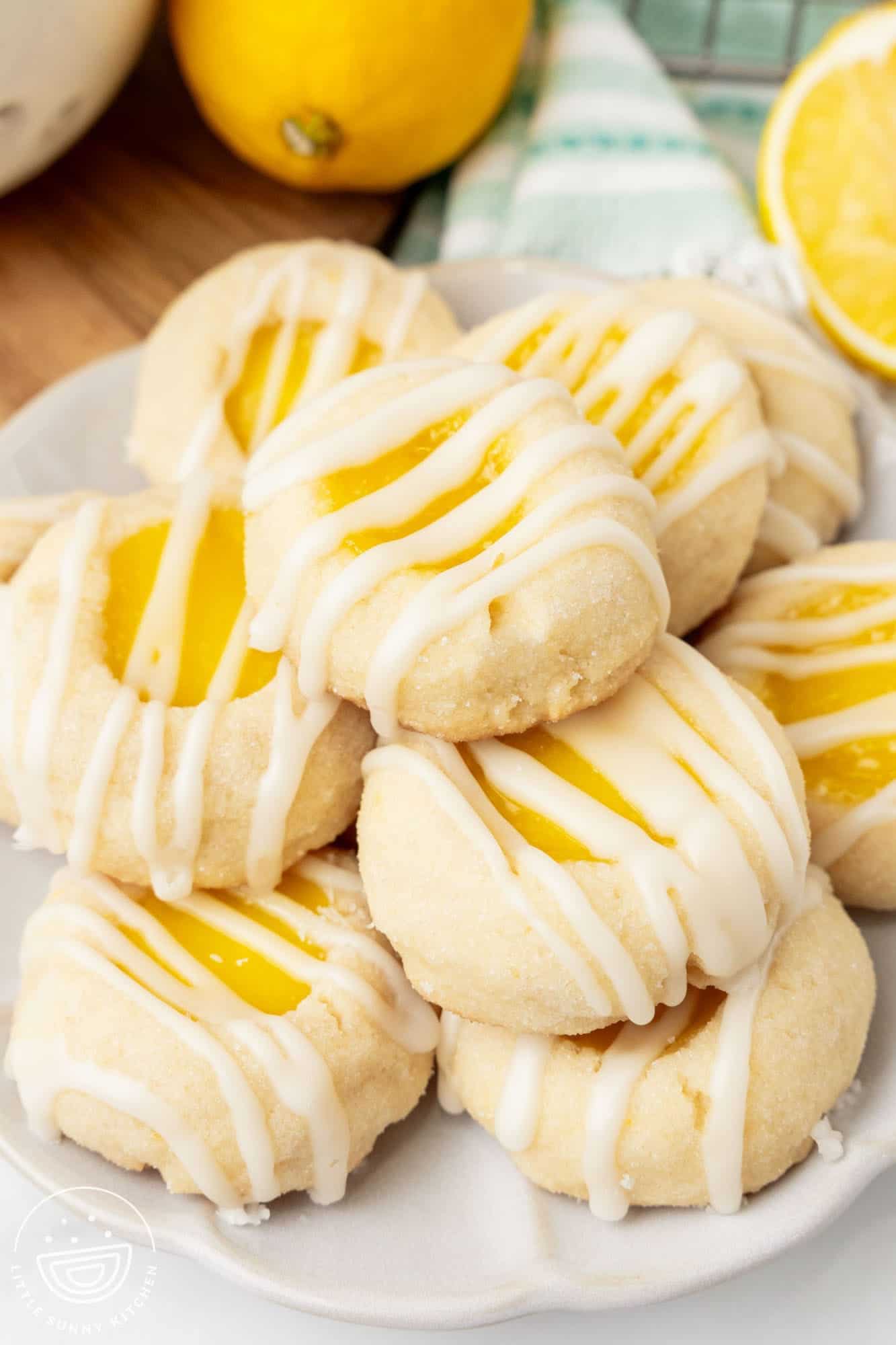 a plate holding a stack of lemon curd cookies with drizzled icing.