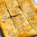 baked spinach pie greek pastry cut into squares.