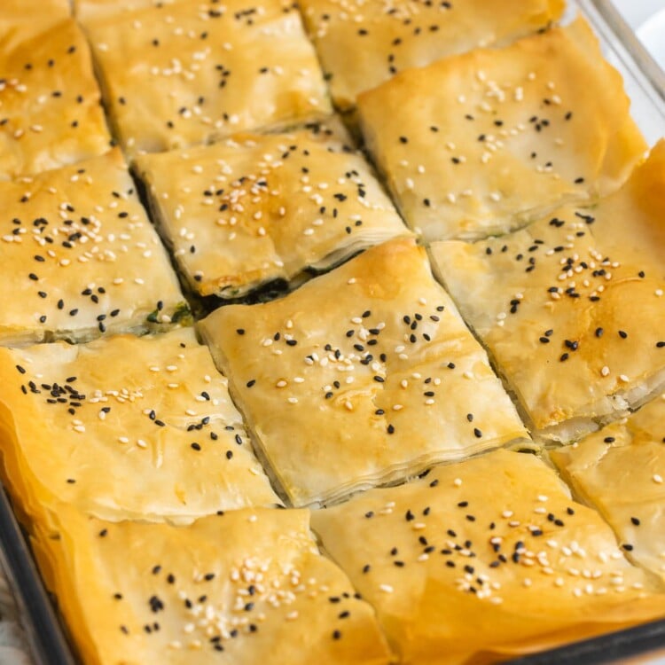 baked spinach pie greek pastry cut into squares.