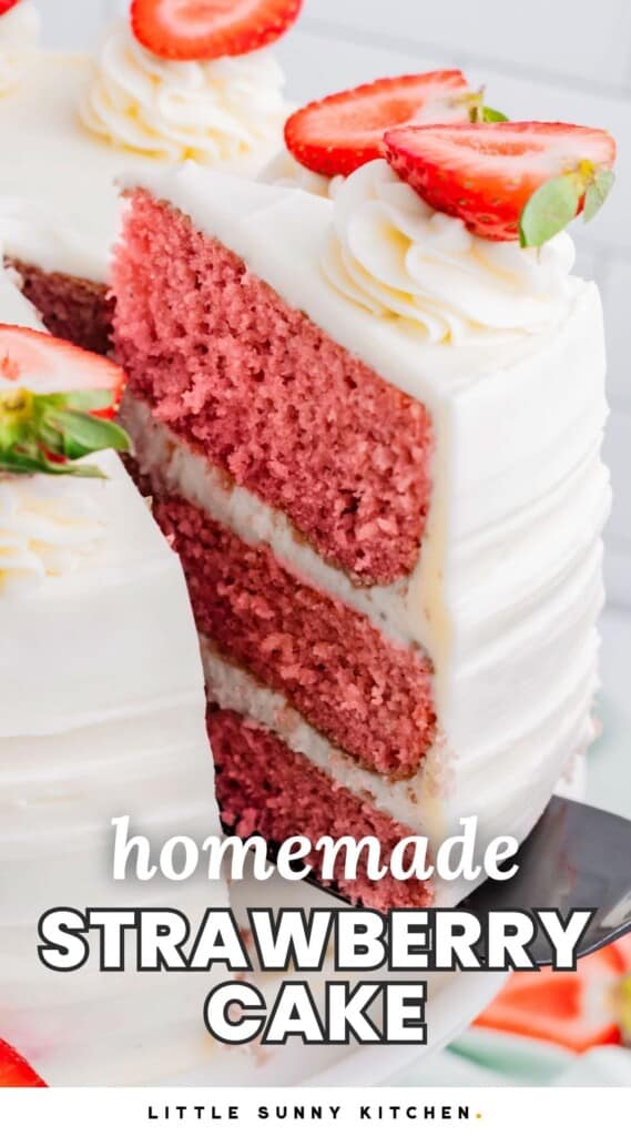 A cake server lifting a wedge of pink cake with white frosting. This is a three layer cake with fresh strawberries on top. Text overlay at bottom of image says "homemade Strawberry cake"