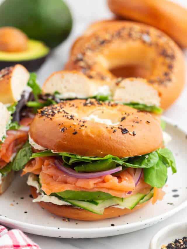 a white plate holding an everything babel filled with veggies and smoked salmon