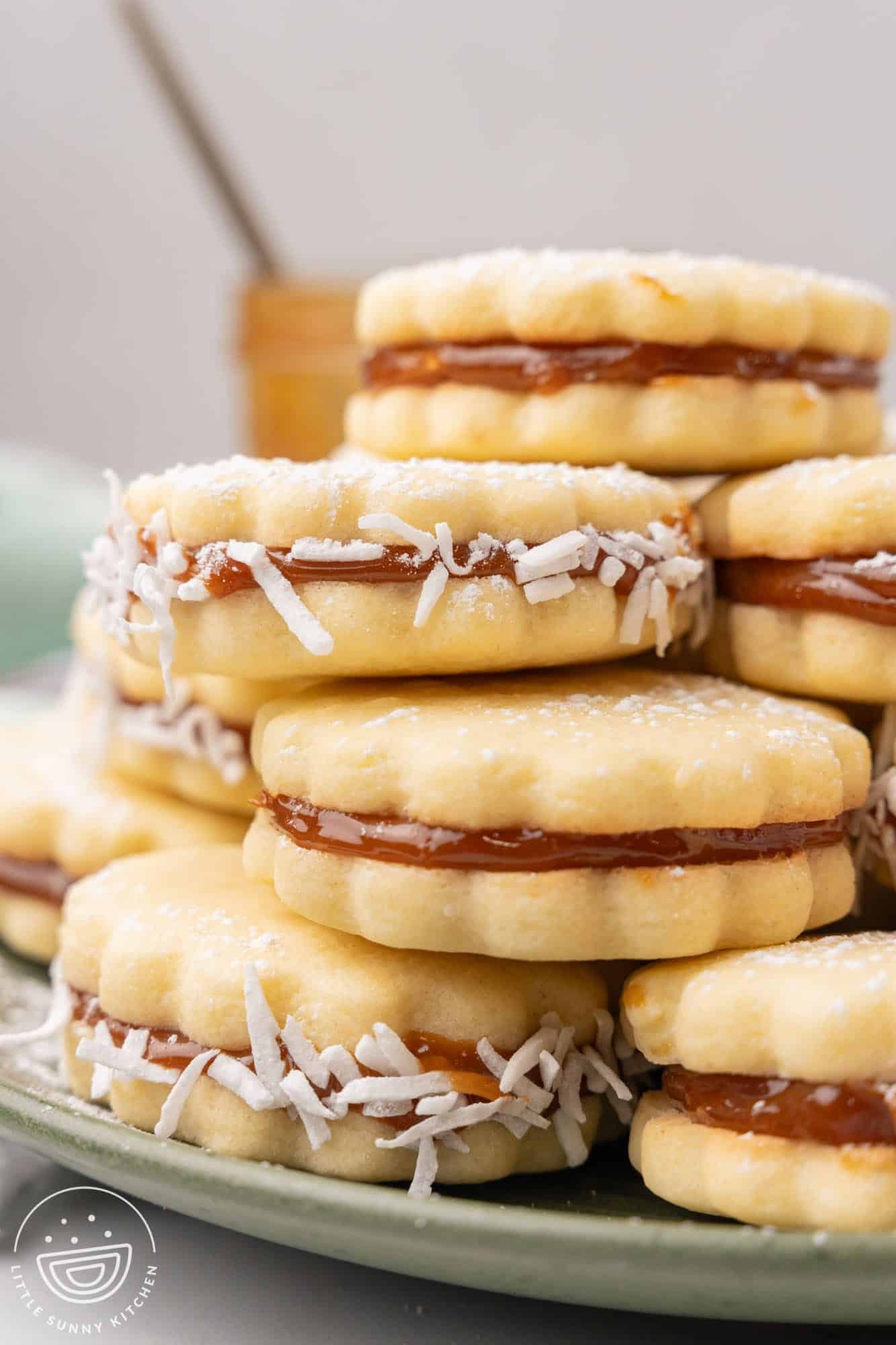 closeup of a stack of dulce de leche sandwich cookies with coconut.