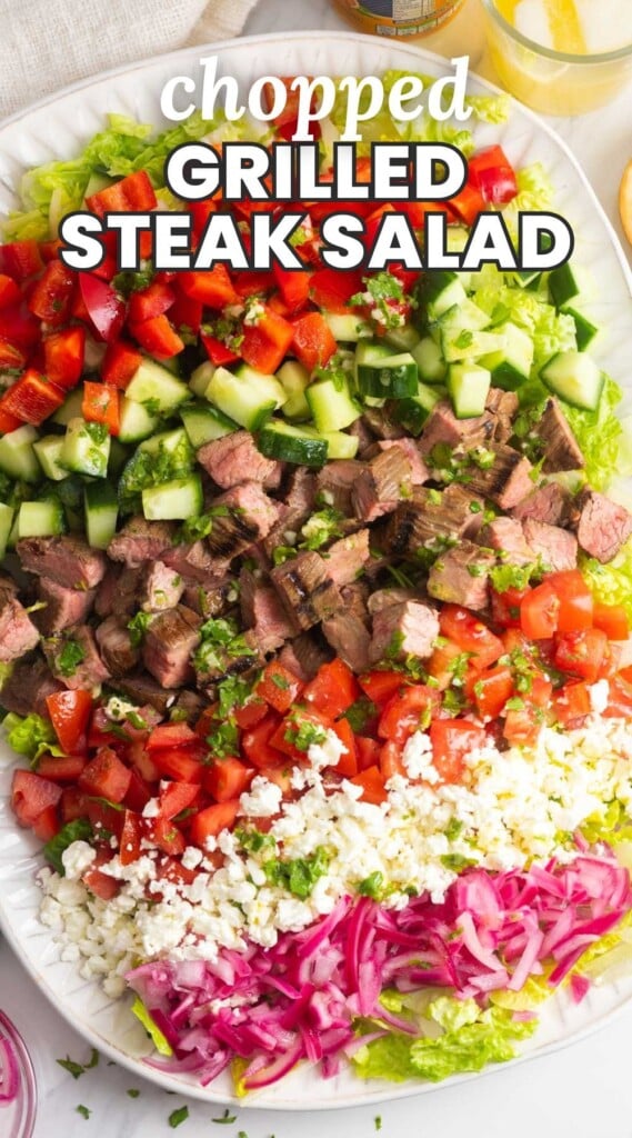 a salad with steak, vegetables and feta cheese. Text overlay says "chopped grilled steak salad"
