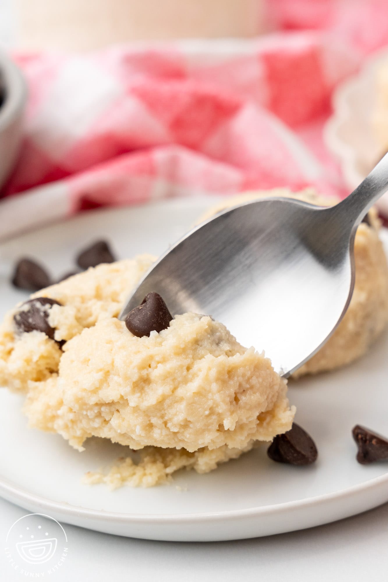 a spoon picking up a bite of cottage cheese cookie dough.