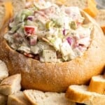 a platter of sliced bread. In the center is a large bread bowl filled with Italian Hoagie Dip.