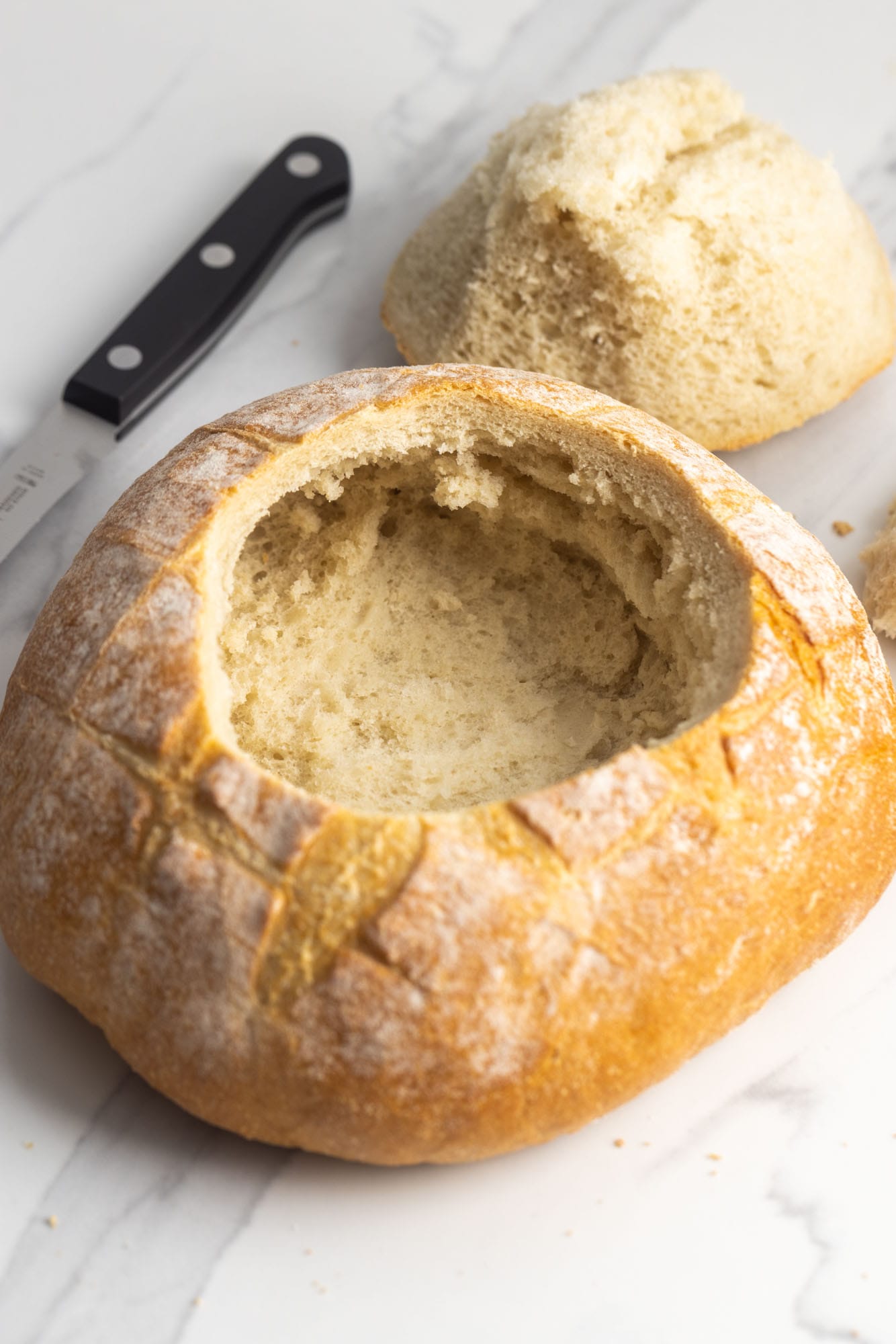 a round loaf of bread with the top removed and made into a bread bowl.