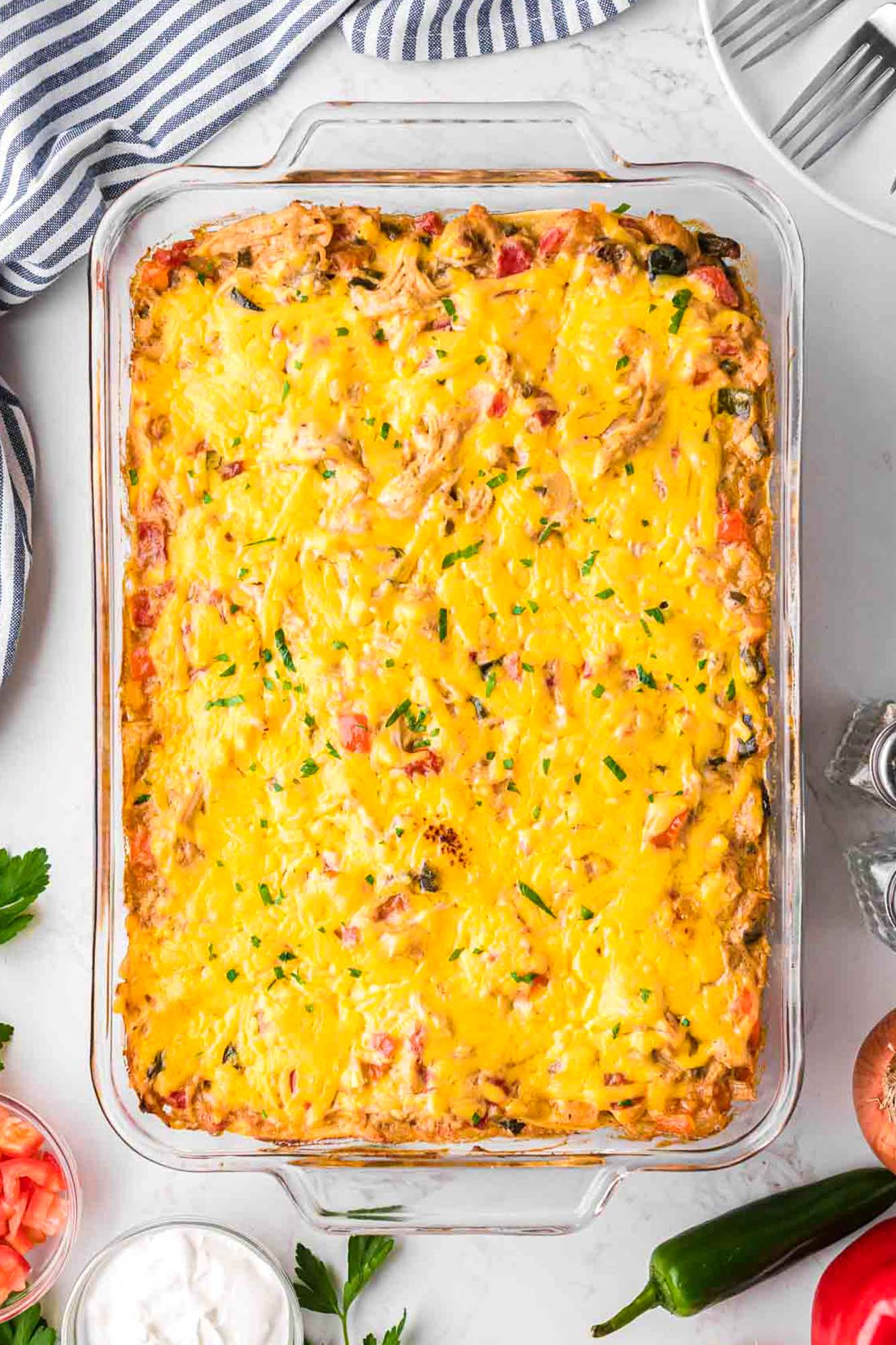 baked king ranch chicken casserole in a clear glass 9x13 dish, viewed from above. 