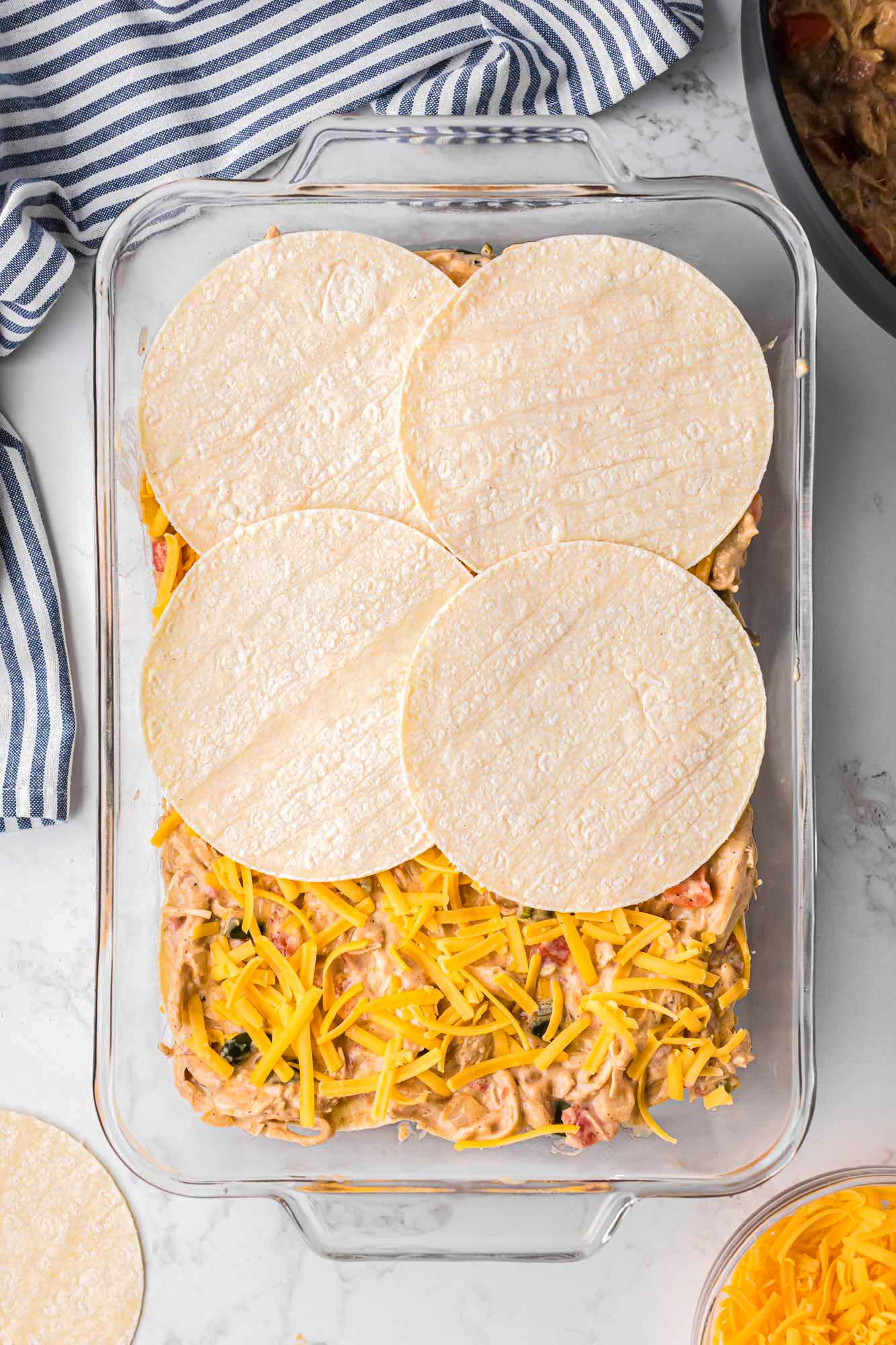 four flour tortillas added to create a layer of king ranch chicken casserole. 