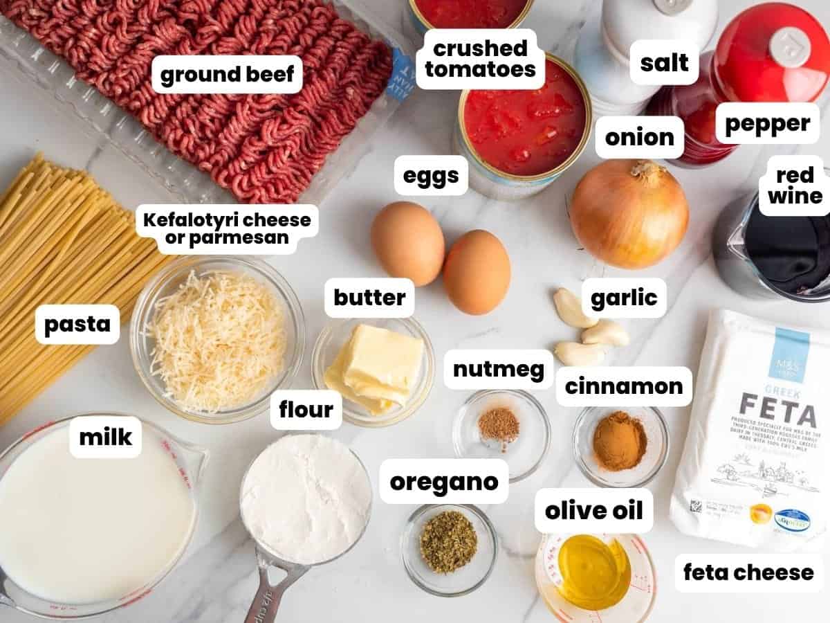 The ingredients needed to make greek lasagna with pasta, ground beef, and feta cheese