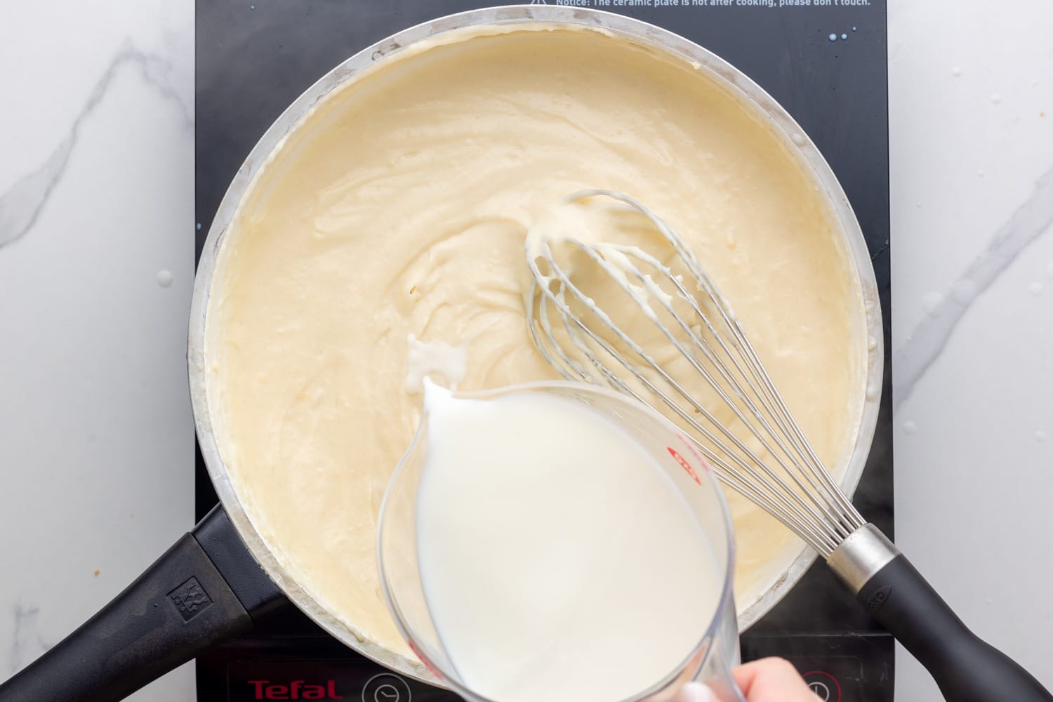 milk whisked into roux for bechamel sauce