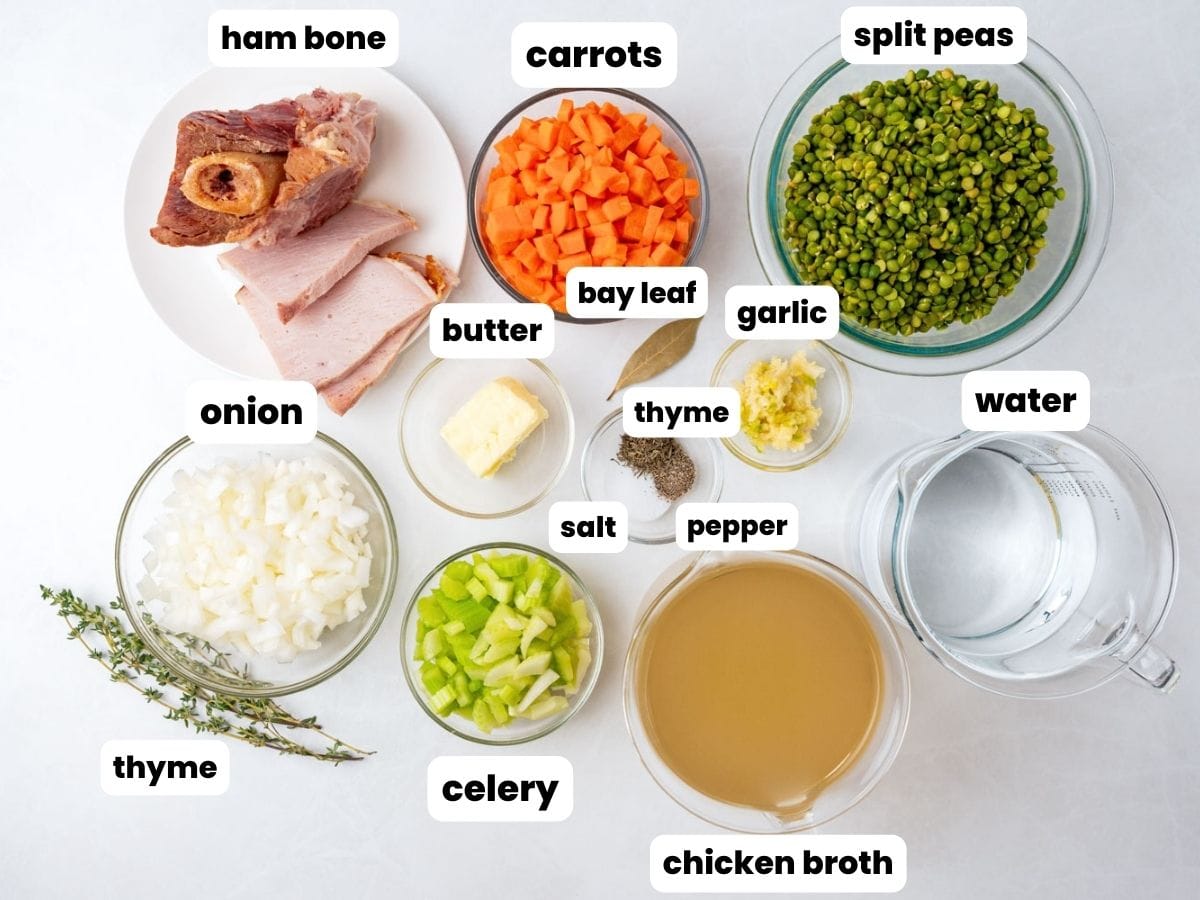 The ingredients needed to make split pea soup with a ham bone, arranged on a counter.