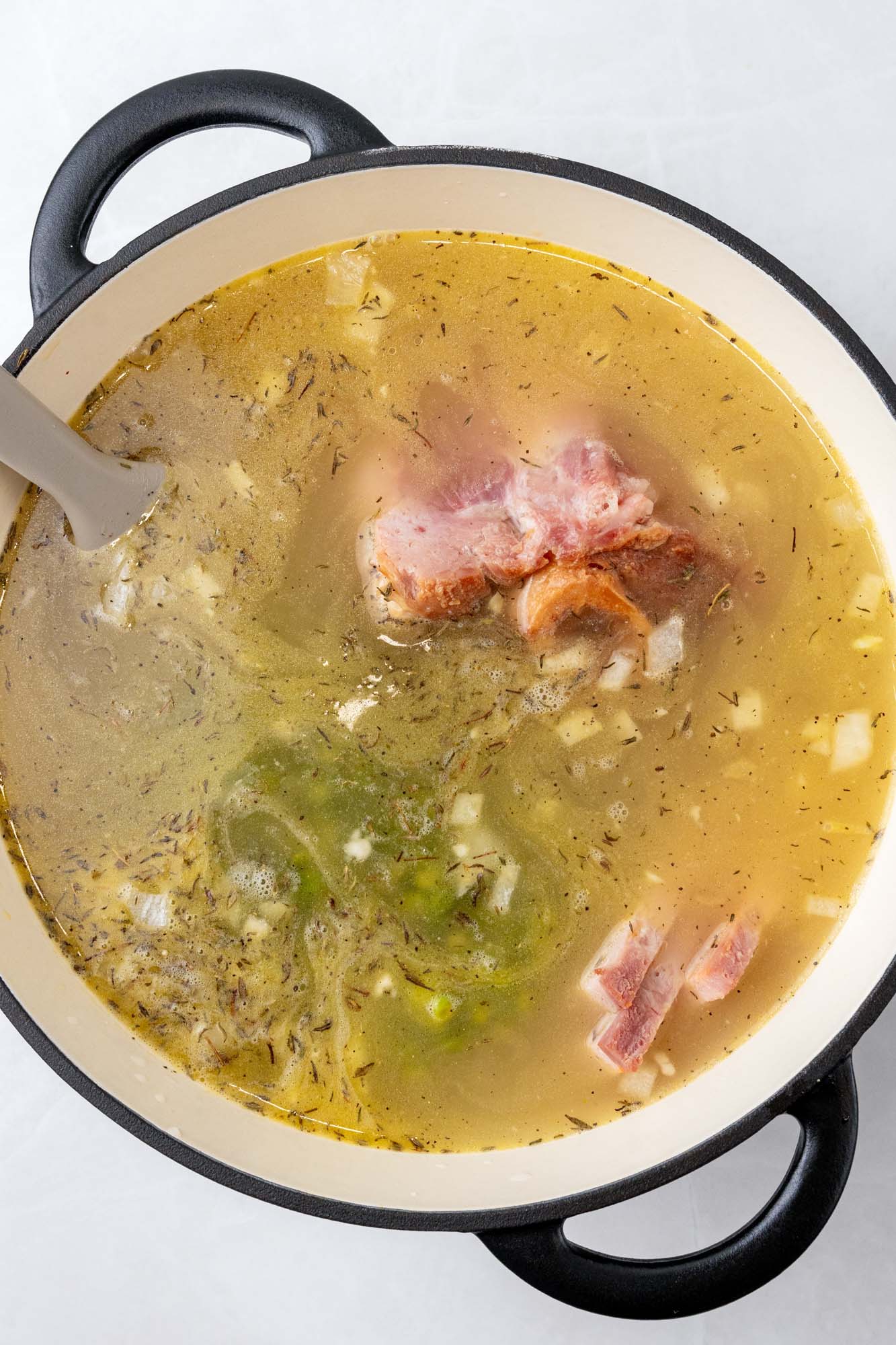 a pot of split pea soup with ham, simmering.