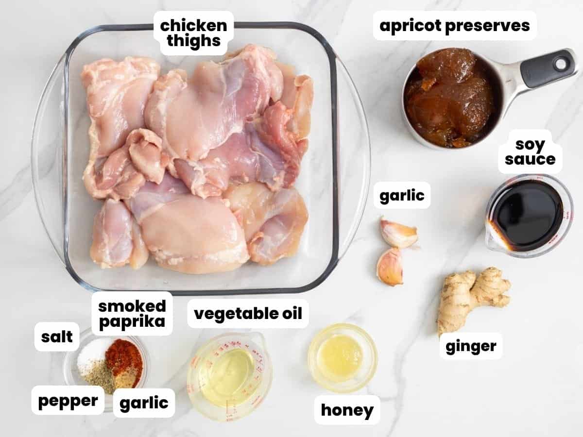 The ingredients needed to make chicken with apricot glaze, including apricot preserves, soy sauce, garlic, ginger, honey, oil, and seasonings.