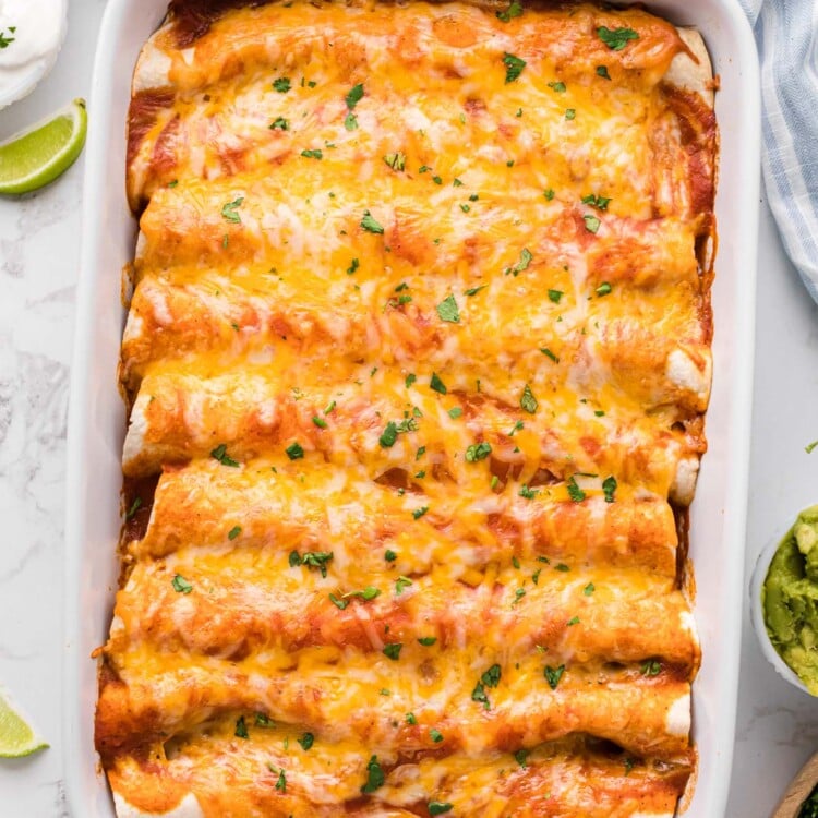 top down view of cheesy beef enchiladas in a casserole pan.