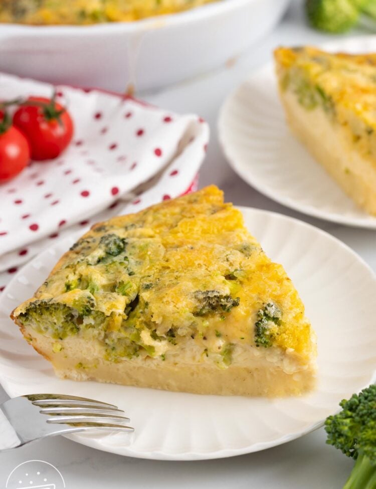a slice of impossible quiche with broccoli and cheese on a small plate with a fork.