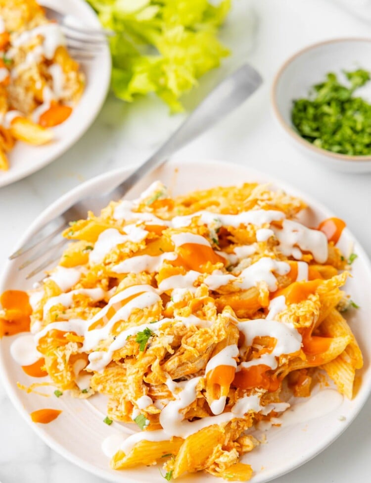 a serving of buffalo chicken casserole on a white plate with a fork.