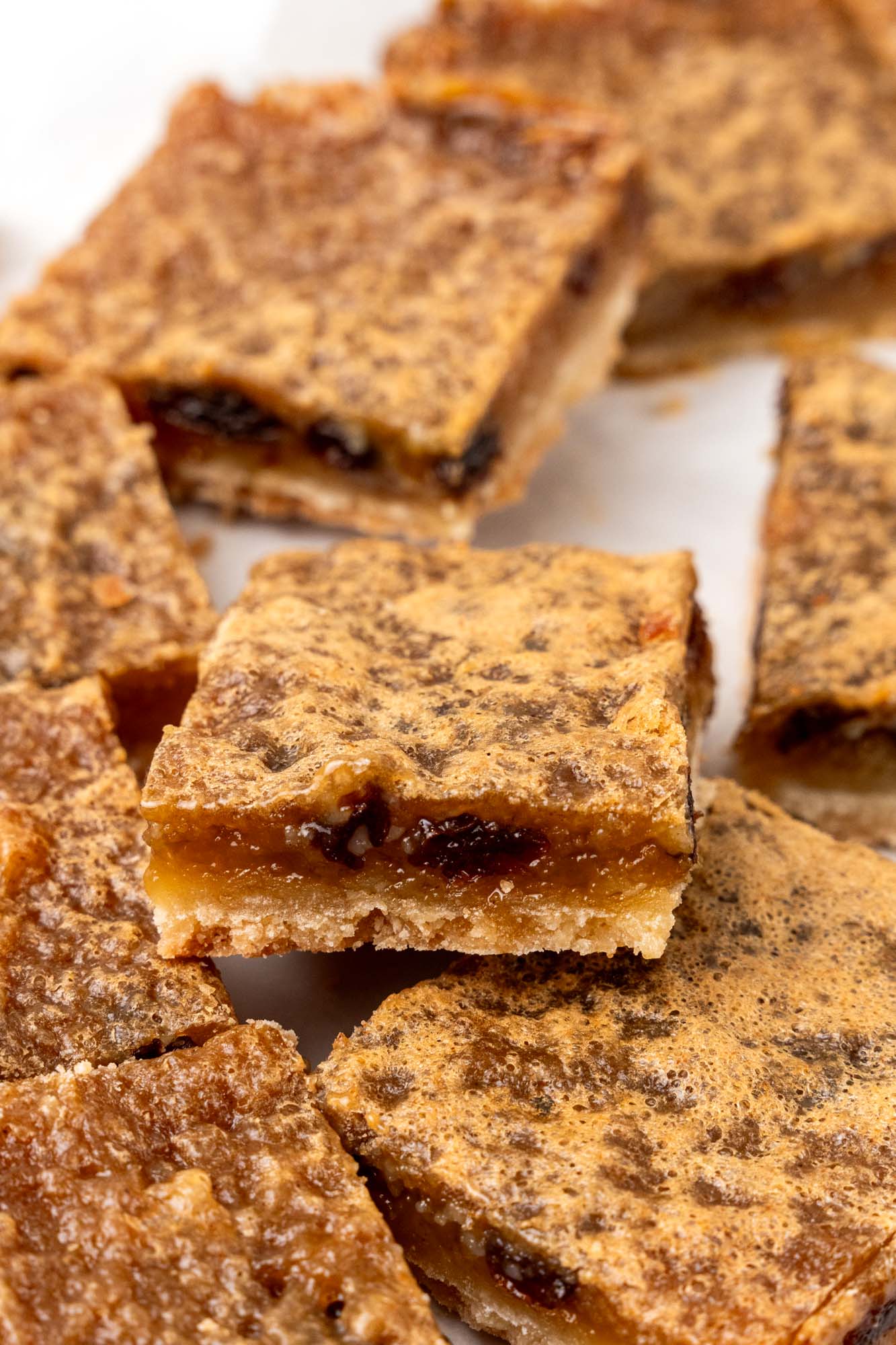 Canadian butter tart bars cut into squares and arranged on a counter.