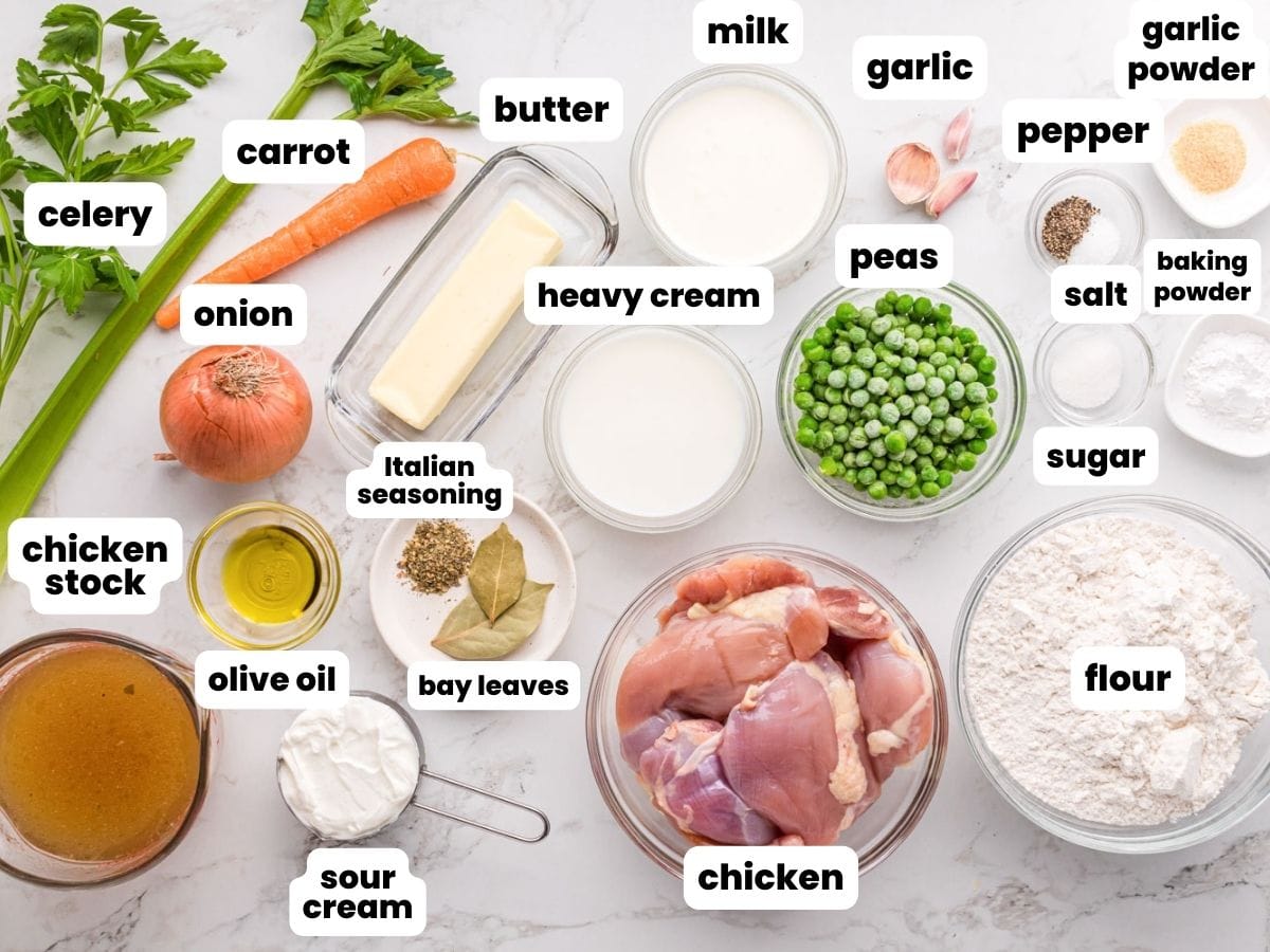 The ingredients needed to make chicken and dumplings, all measured into small bowls and labeled with text boxes.