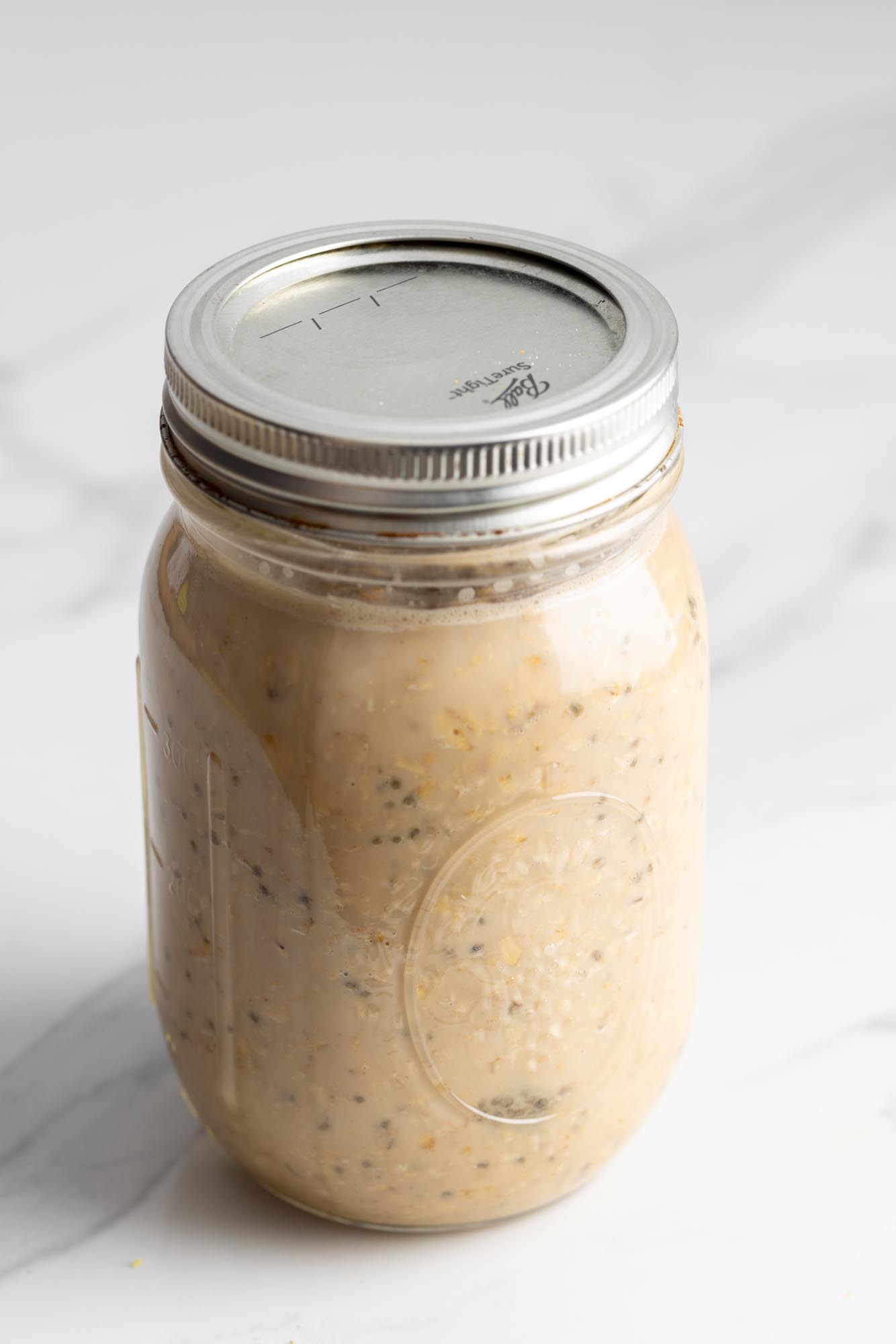 Sealed mason jar filled with coffee overnight oats