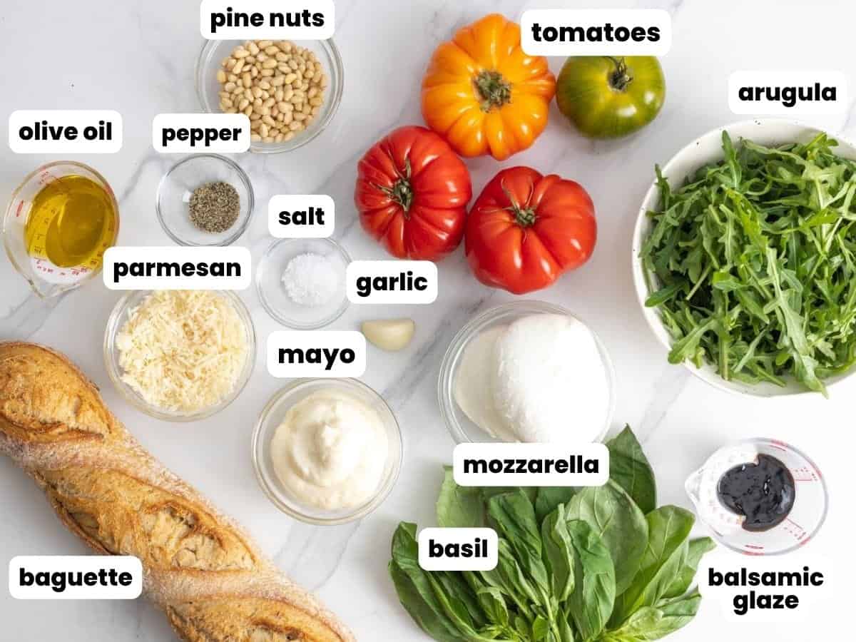 The ingredients needed to make a fresh Caprese sandwich on a baguette.