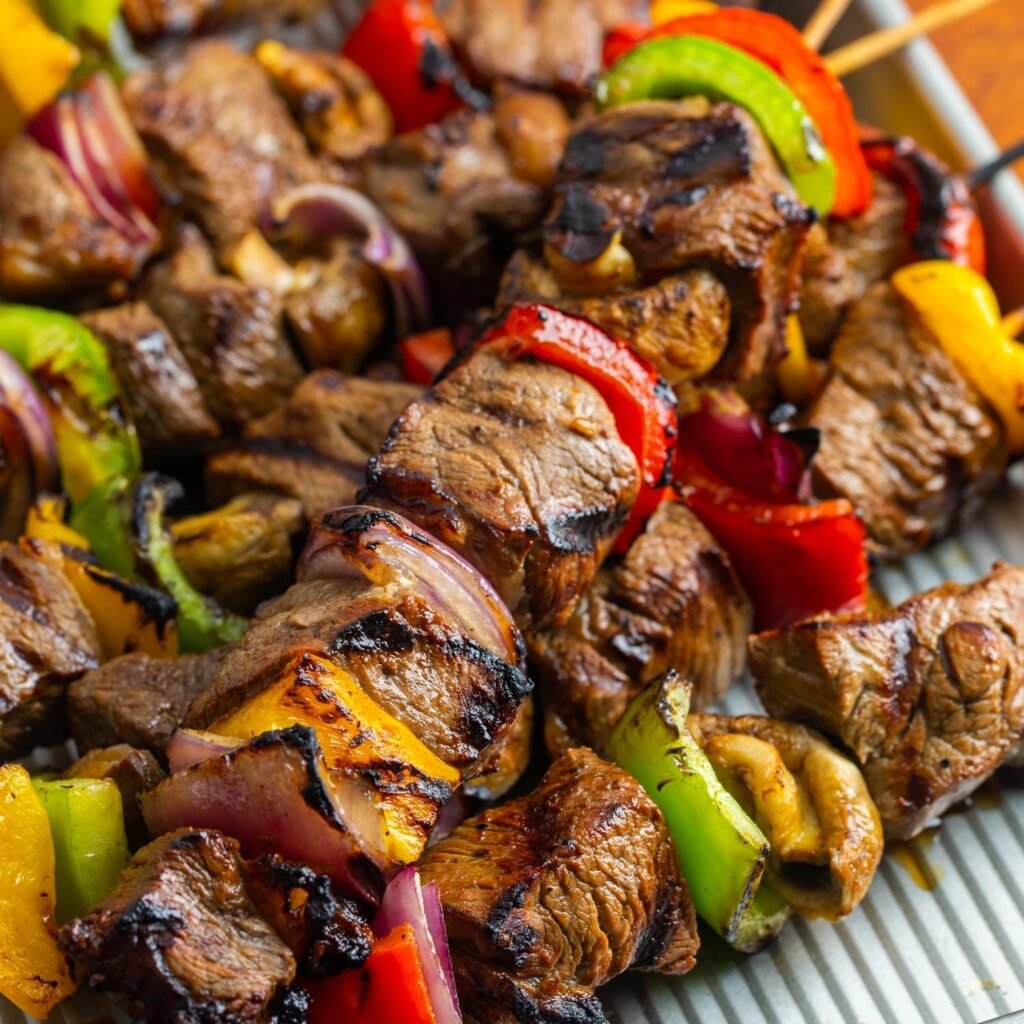 grilled beef kabobs with veggies on a sheet pan.
