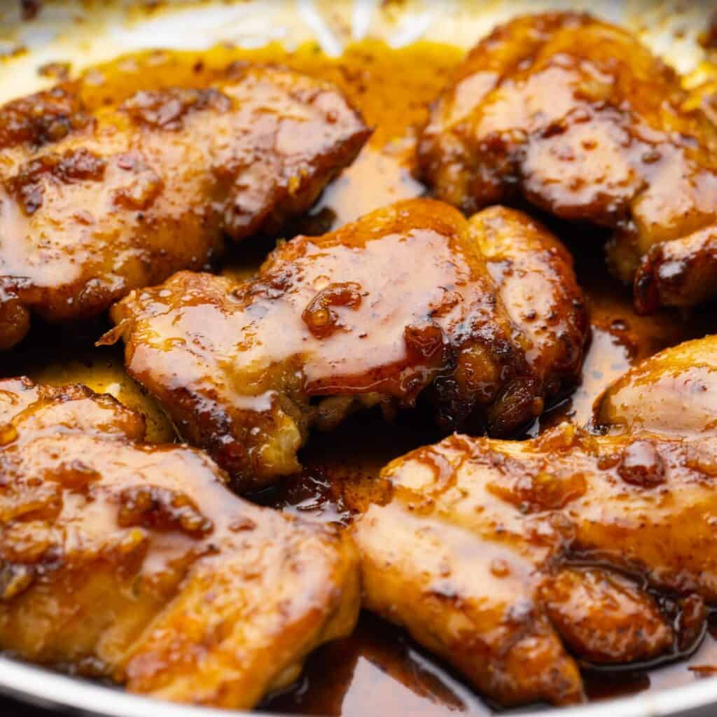 closeup of honey lime chicken thighs with a sweet and tangy sticky sauce.