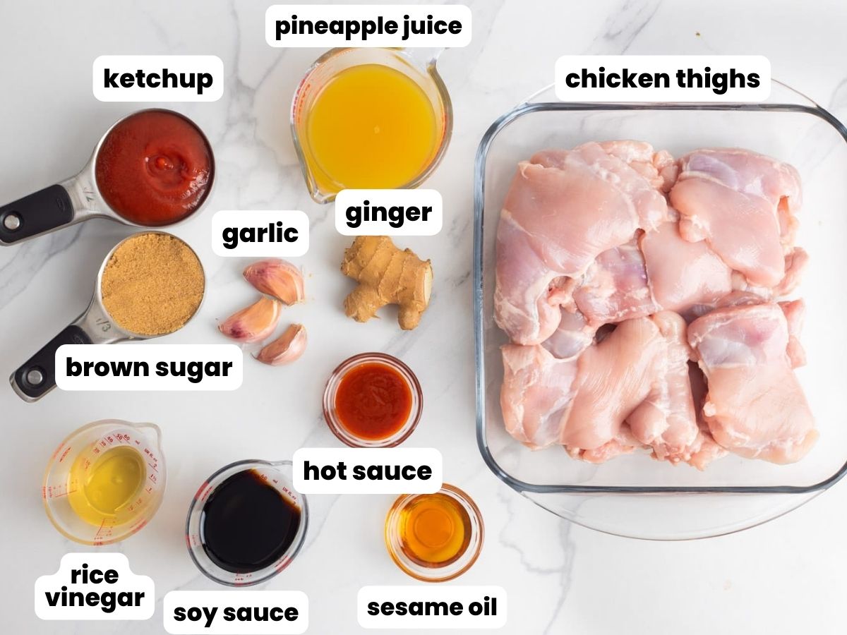 a glass dish of boneless chicken thighs along with the ingredients to make huli huli chicken.