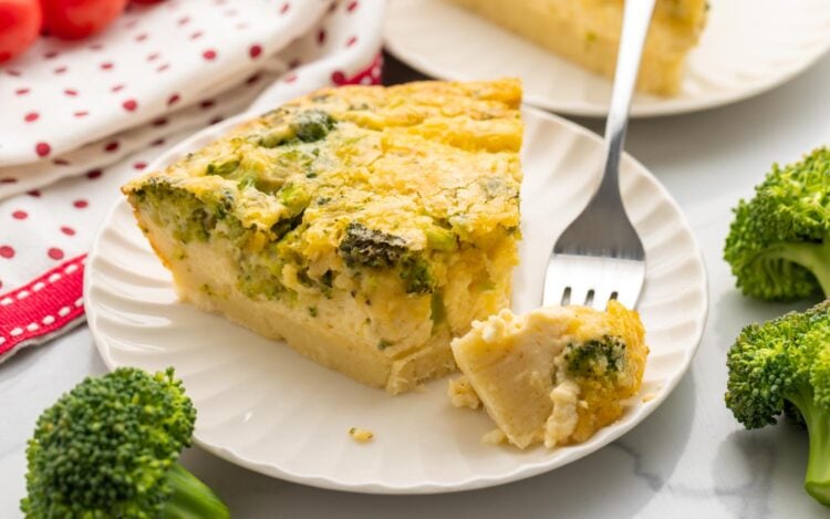 Bisquick impossible quiche on a small white plate, with a fork on the side taking a bite