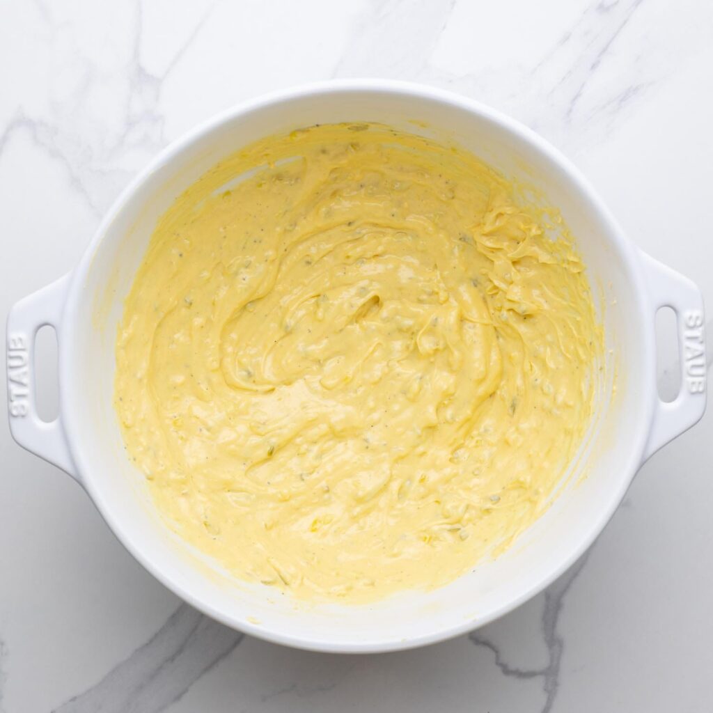 mayo dressing for deviled egg salad in a large bowl.
