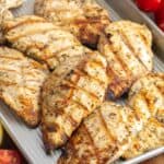 greek grilled chicken cutlets on a small sheet pan.