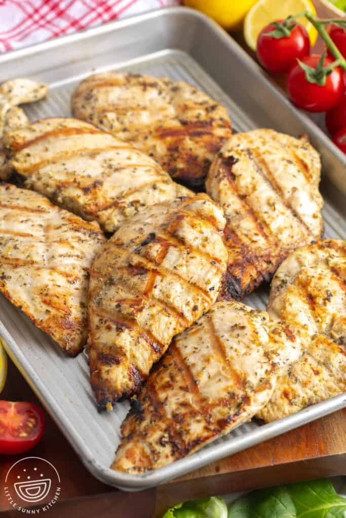 greek grilled chicken cutlets on a small sheet pan.