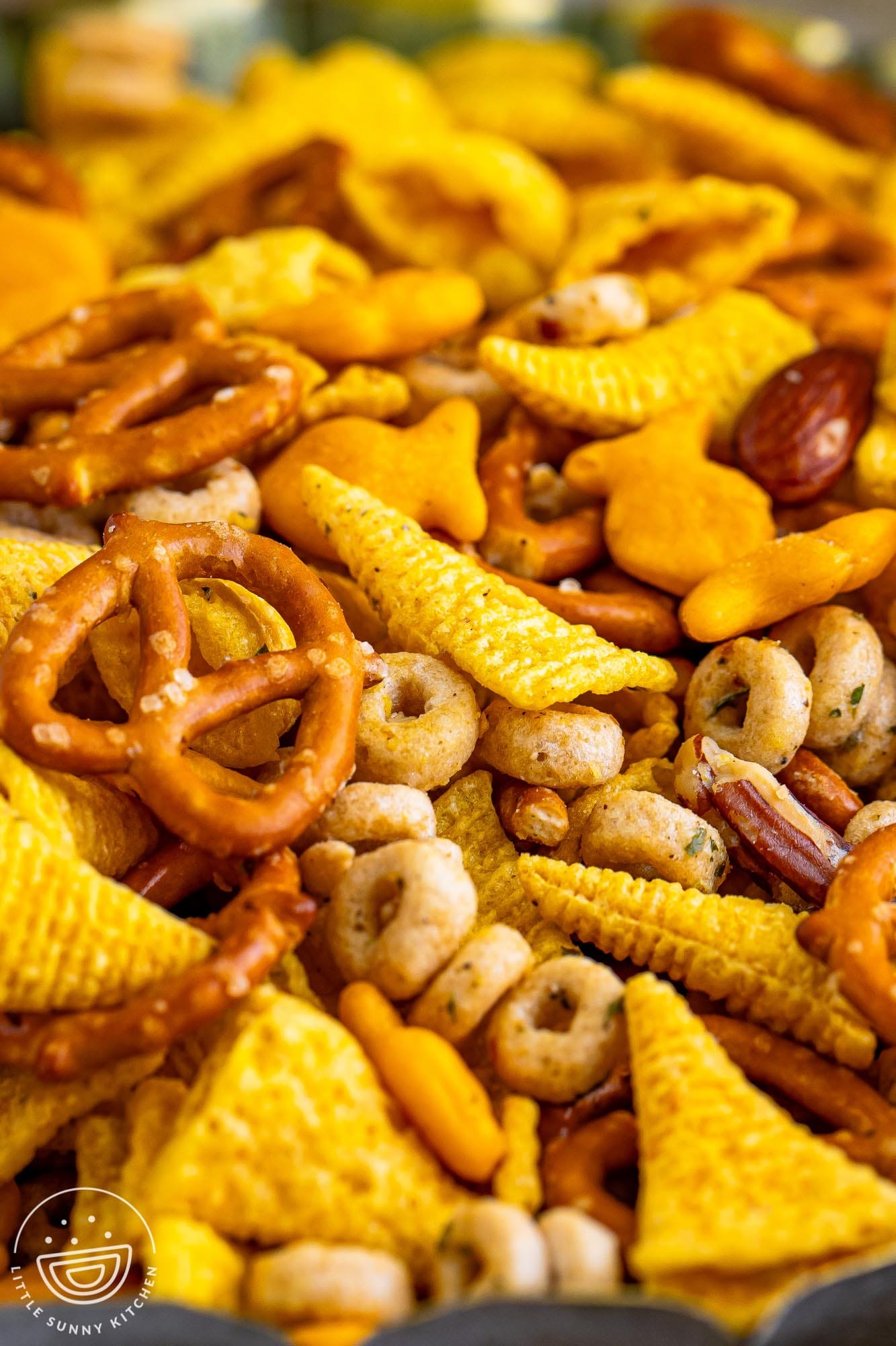 Closeup of Ranch Bugles snack mix with pretzels, cheerios, goldfish.