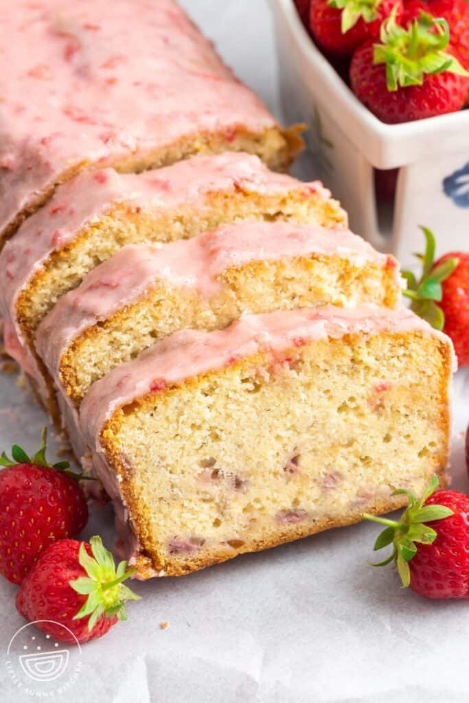 sliced strawberry pound cake with strawberry icing.