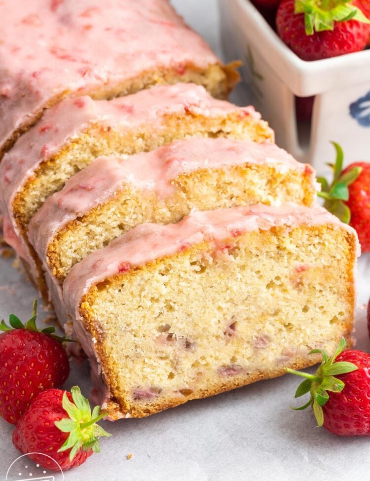 sliced strawberry pound cake with strawberry icing.