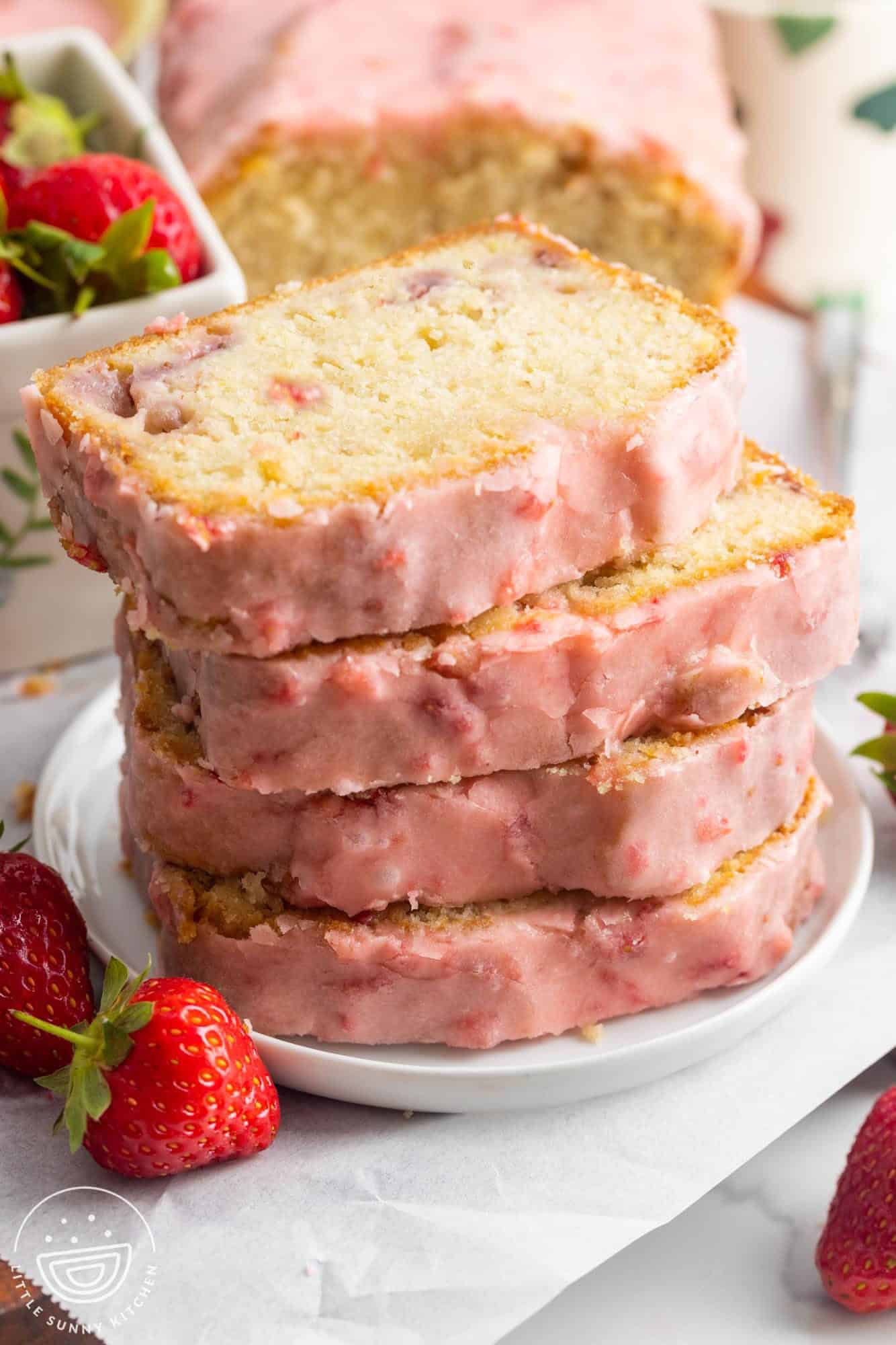 a plate holding four slices of strawberry pound cake.