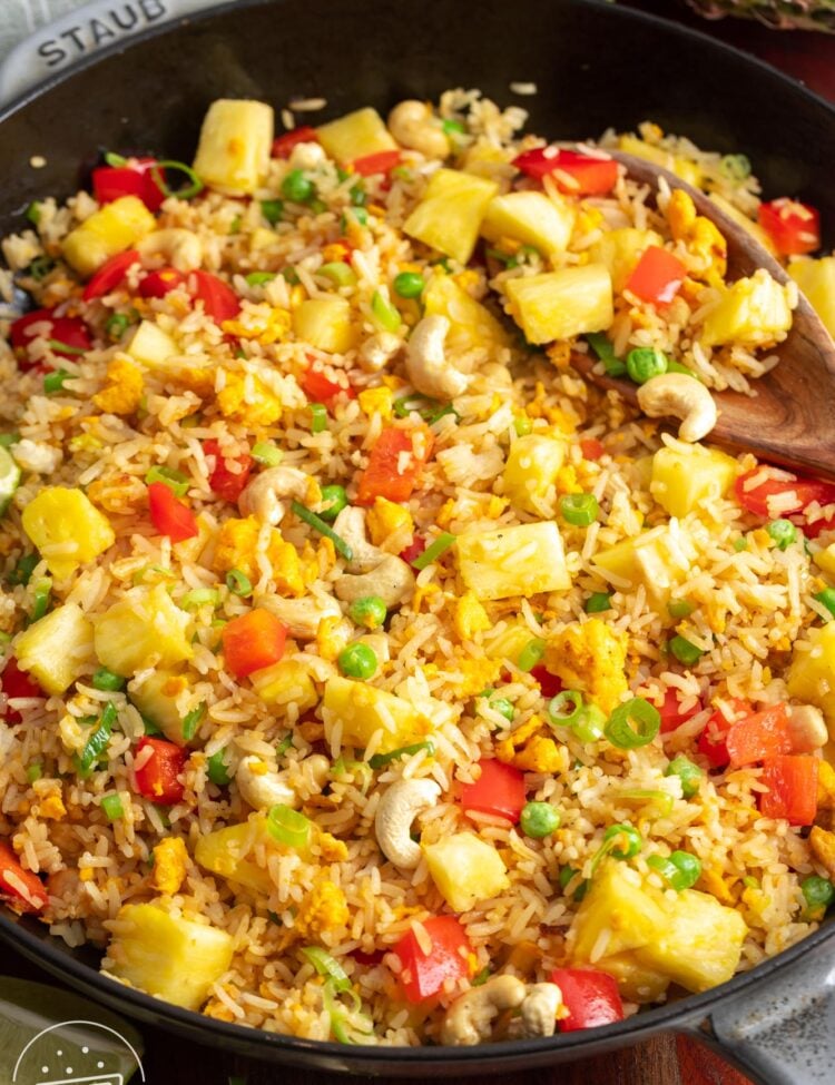 a cast iron skillet filled with Thai pineapple fried rice.