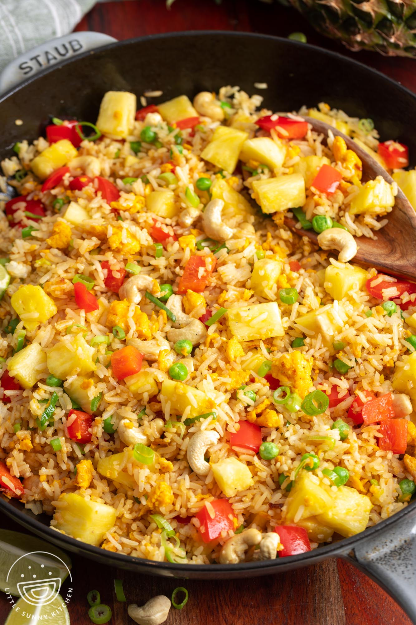 a cast iron skillet filled with Thai pineapple fried rice.