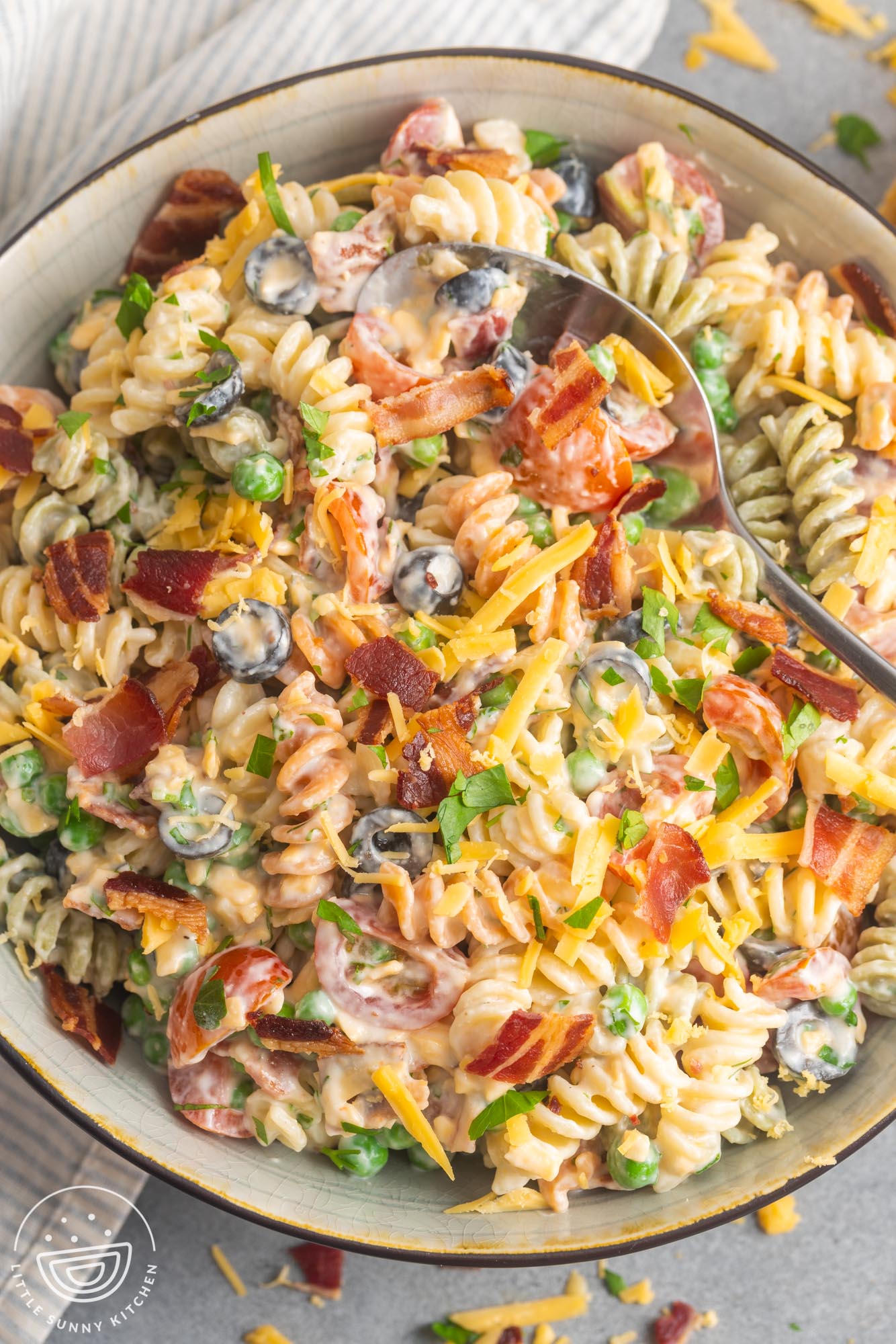 overhead view of a serving bowl filled with creamy bacon ranch pasta salad.